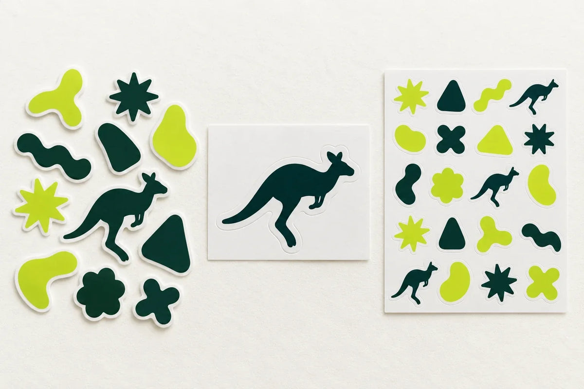 Three kinds of vinyl sticker on white paper: loose die cut shapes, a kangaroo kiss cut sticker on its backing sheet, and a sticker sheet of small lime and green shapes