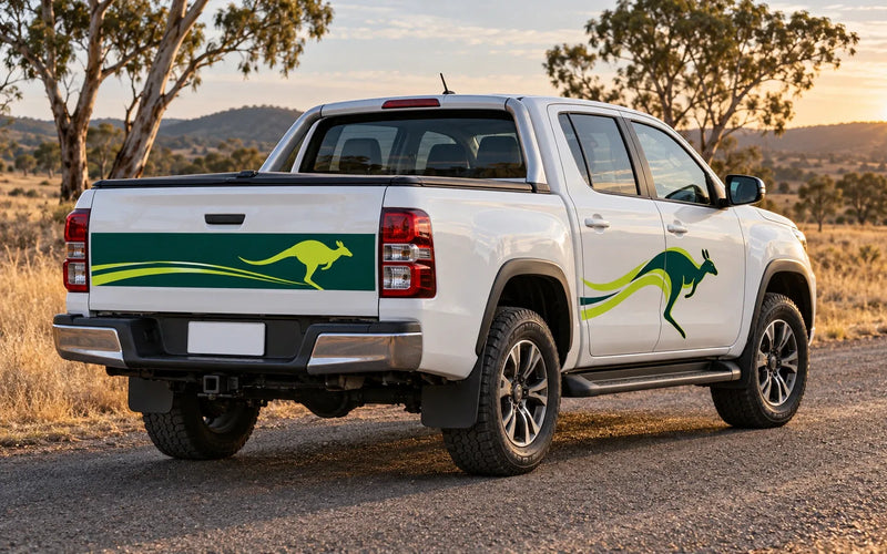White dual cab ute on a country road with a kangaroo decal on the rear door and a long decal across the tailgate, windows and number plate left clear